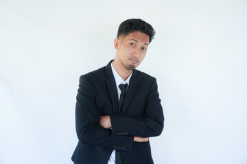 Adult Asian man wearing black suit and tie showing fierce face with his hands on hip