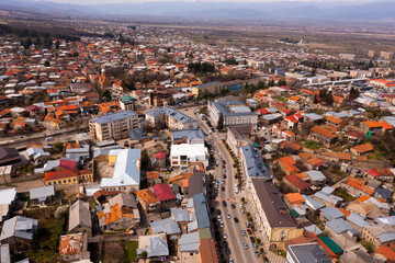 Panoramic aerial view of old Georgian town of Telavi overlooking modern buildings on central street in springtime, Kakheti