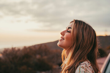 Portrait close up of face of one young beautiful woman smiling with closed eyes enjoying freedom...