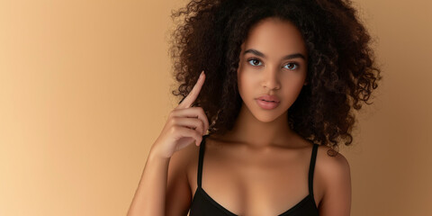 Fototapeta premium Young Woman in Tank Top Making Playful Gestures Against Background