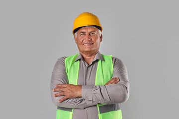 Engineer in hard hat on grey background