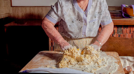 Unrecognizable senior Grandmother's Kitchen: Kneading Dough by Hand.