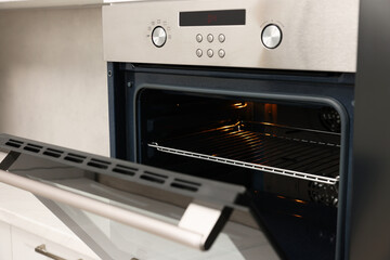 Obraz premium Open electric oven in kitchen. Cooking appliance