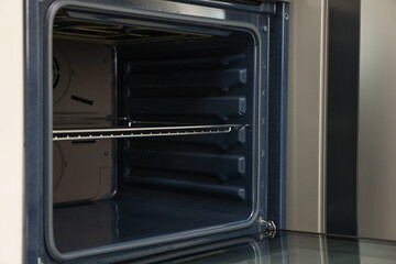 Fototapeta premium Open electric oven in kitchen. Cooking appliance
