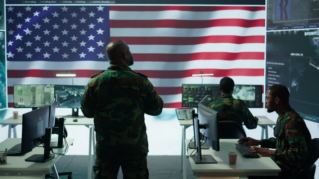 Team of military experts operates high tech computers and tablet to analyze surveillance data and manage national security operations. Working with CCTV radar satellite imagery. Camera B.