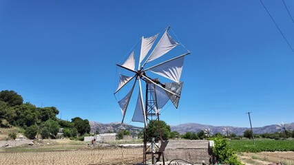 Lassithi Crete Greece. 18.07.2024. Metal windmill with turning sails to pump water for irrigation on this famous plateau in Crete.