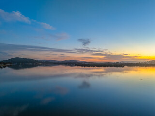 Sunrise along the waterfront with reflections on the bay water