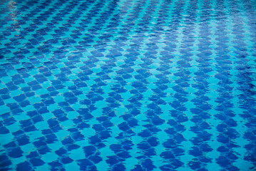 Poolside background Blue swimmimg pool reflection ripple wave underwater. Turquoise paradise shiny outdoors party in luxury hotel. Summer Outdoors lifestyle tourist vacation background swimming pool