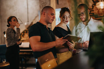 Group of young entrepreneurs brainstorming and discussing strategies in a modern office environment to achieve business success and growth.
