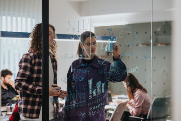 Dynamic business environment scene, showing a team of professionals collaborating and brainstorming using sticky notes and markers on a transparent glass wall filled with statistical data.