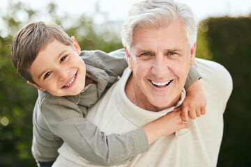 Piggyback, portrait or love with grandpa and boy child outdoor in garden of home together for...