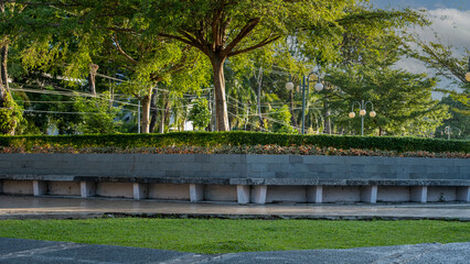 Obraz premium view of the city park with concrete benches and lights, beautiful and beautiful garden with big trees and bonsai city park. Environmental care theme background concept