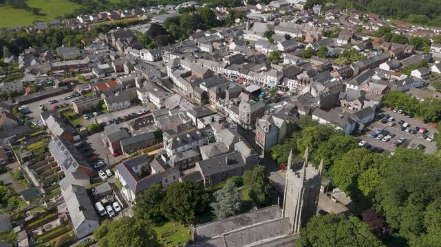 Aerial orbital view showcasing Holsworthy town centre's layout, highlighting its blend of residential and commercial areas, Devon, United Kingdom