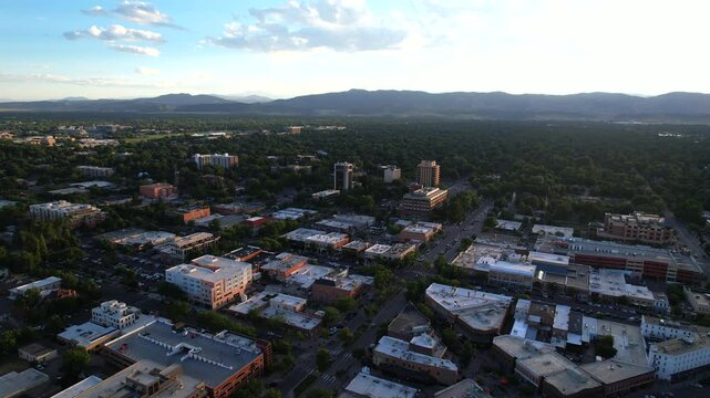 Aerial Drone flight over the main street of Fort Collins Colorado at sunset. Cars driving