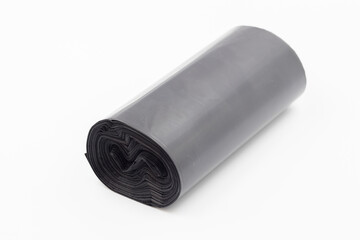 Black plastic garbage bags on white background, Roll of garbage bags on white background