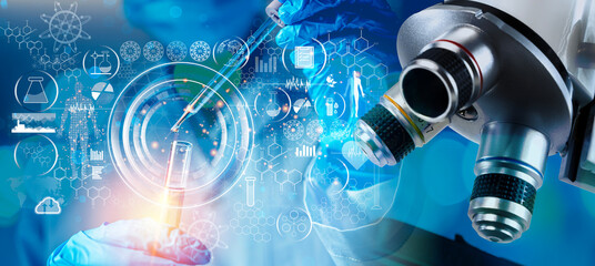 Medical research laboratory. A scientist works with a pipette and a test tube.