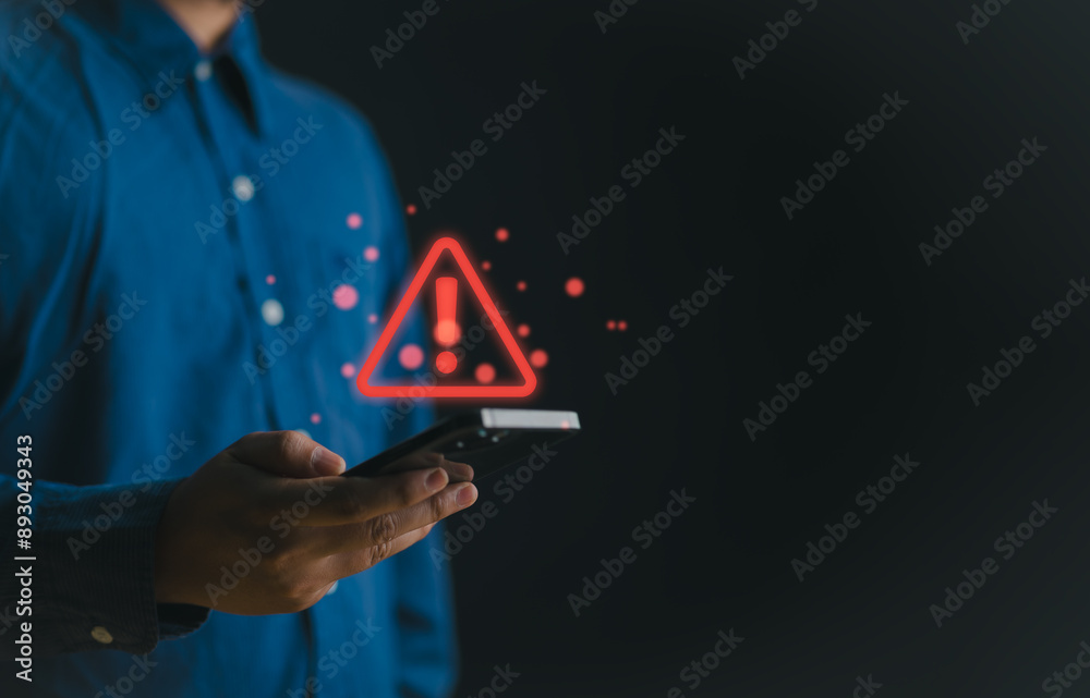 Poster Businessman or User holding smartphone with triangle caution warning sign red for notification error and maintenance concept. Warning sign exclamation.