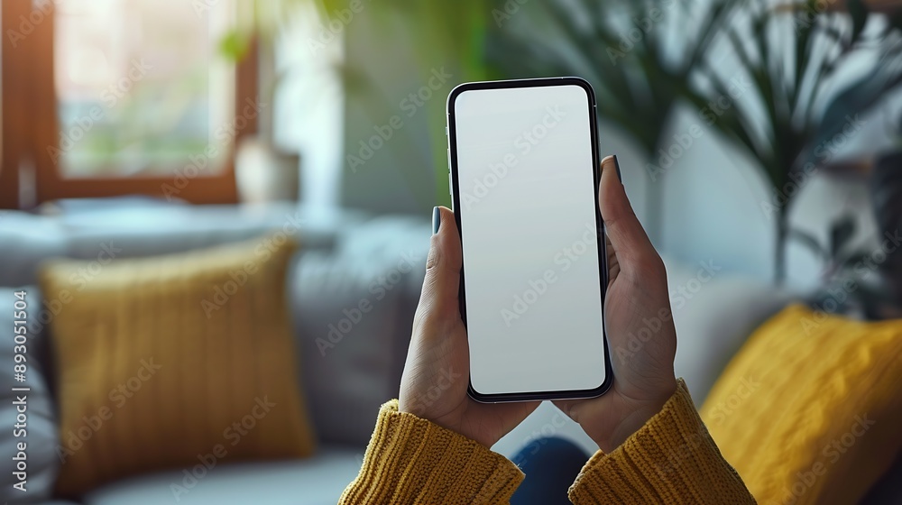 Poster mockup image of a woman holding and using mobile phone with blank desktop white screen at home : gen