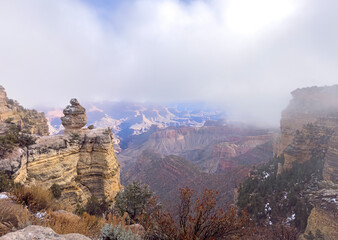 Discover the breathtaking beauty of the Grand Canyon in Arizona, featuring dramatic cliffs, mist-covered rock formations, and vast, panoramic views.