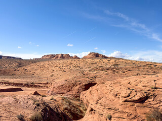 Explore the vast and rugged desert landscape of Arizona, USA, with its stunning rock formations and clear blue sky. This panoramic view captures the serene and unspoiled beauty of the arid Southwest.