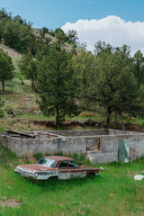 Abandoned rusted car on farmland near Taos, New Mexico, United States Of America.