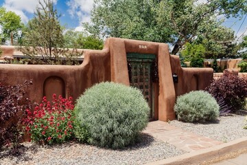 Fototapeta premium Fence of a Pueblo style house in Santa Fe, New Mexico, United States Of America.