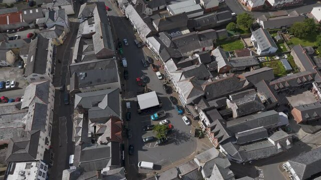 Aerial orbital view of Holsworthy town centre, capturing the layout and architecture of the area, Devon, UK