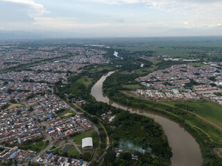 Fototapeta premium Aerial views of the Cauca River in eastern Cali, Colombia
