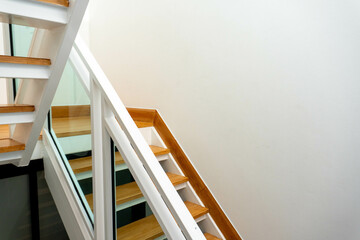 Modern wooden and glass staircase in new house interior.