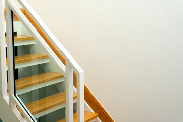 Modern wooden and glass staircase in new house interior.