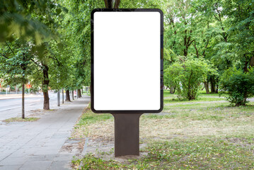 Blank Billboard Mockup Stand In A City Park. Vertical Street Poster Advertising Between Green Trees
