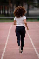 Obraz premium Beautiful curly Asian woman running on the street