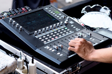 Person moving slider on professional sound mixing desk