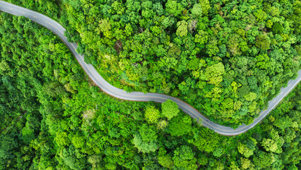 Aerial view of road in the middle of the forest , Top view road curve construction up to mountain,...