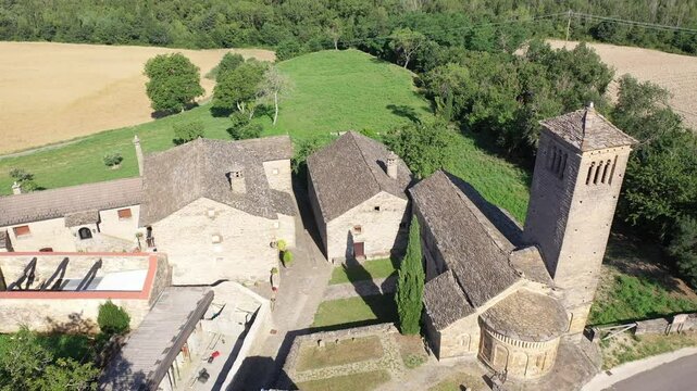 Aerial view of bell tower and apse of the Mozarab Pre-Romanesque or Romanesque Church of San Pedro de Larrede in the Serrablo Region. Aragon. Spain. High quality 4k footage