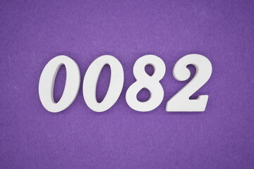 The numbers are made of white paint wood, placed on the background as a purple paper.