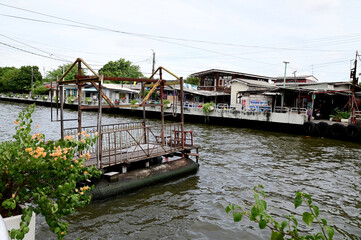 BANGKOK, THAILAND - July 29, 2024 : Wooden raft and iron fence for crossing the Saen Saep Canal and...