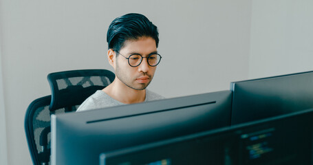 Young adult Asia male freelance eyeglasses typing write prompt AI bot IT app smart program nomad, video game, terminal with coding, user interface, designer, big data center on desktop computer.
