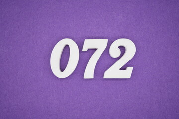 The numbers are made of white paint wood, placed on the background as a purple paper.