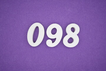The numbers are made of white paint wood, placed on the background as a purple paper.