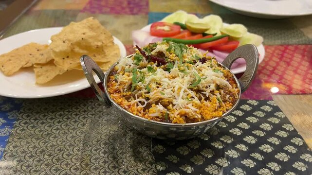 The delicious mutton rara masala served with papad and salad.