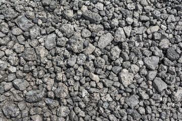 Large pieces of metallurgical slag form a natural backdrop. The texture of the slag waste is