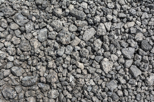 Large pieces of metallurgical slag form a natural backdrop. The texture of the slag waste is