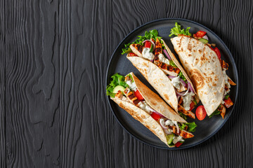 grilled chicken street tacos on a dark plate