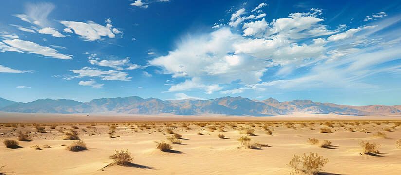 A stunning landscape of the Nevada desert with a wide expanse of golden sand and clear blue skies The photo provides ample space for copy or other content