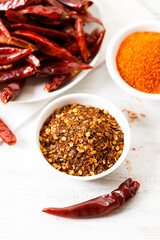 Dried red chilies on white wooden table.