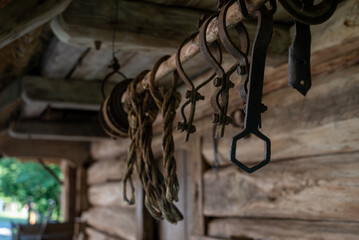old simple tools outside an antique stable in a village