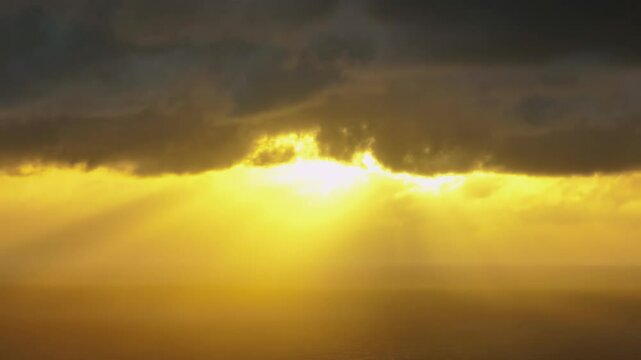 Sun Rays shing through dark clouds. piha, Auckland, New Zealand.