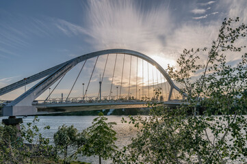 Sun rays through the Puente de la Barqueta bridge, Seville, Spain