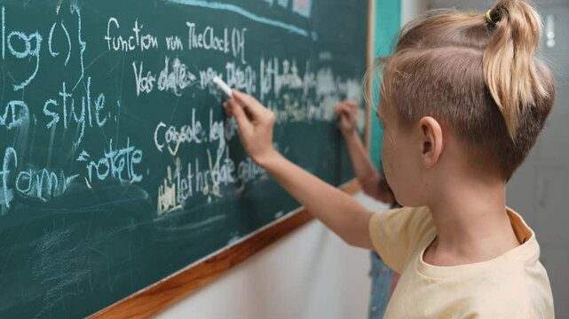 Diverse student studying coding engineering prompt while writing answer on blackboard. Intelligence children planning and learning about coding development plan. Successful boy sharing idea. Pedagogy.